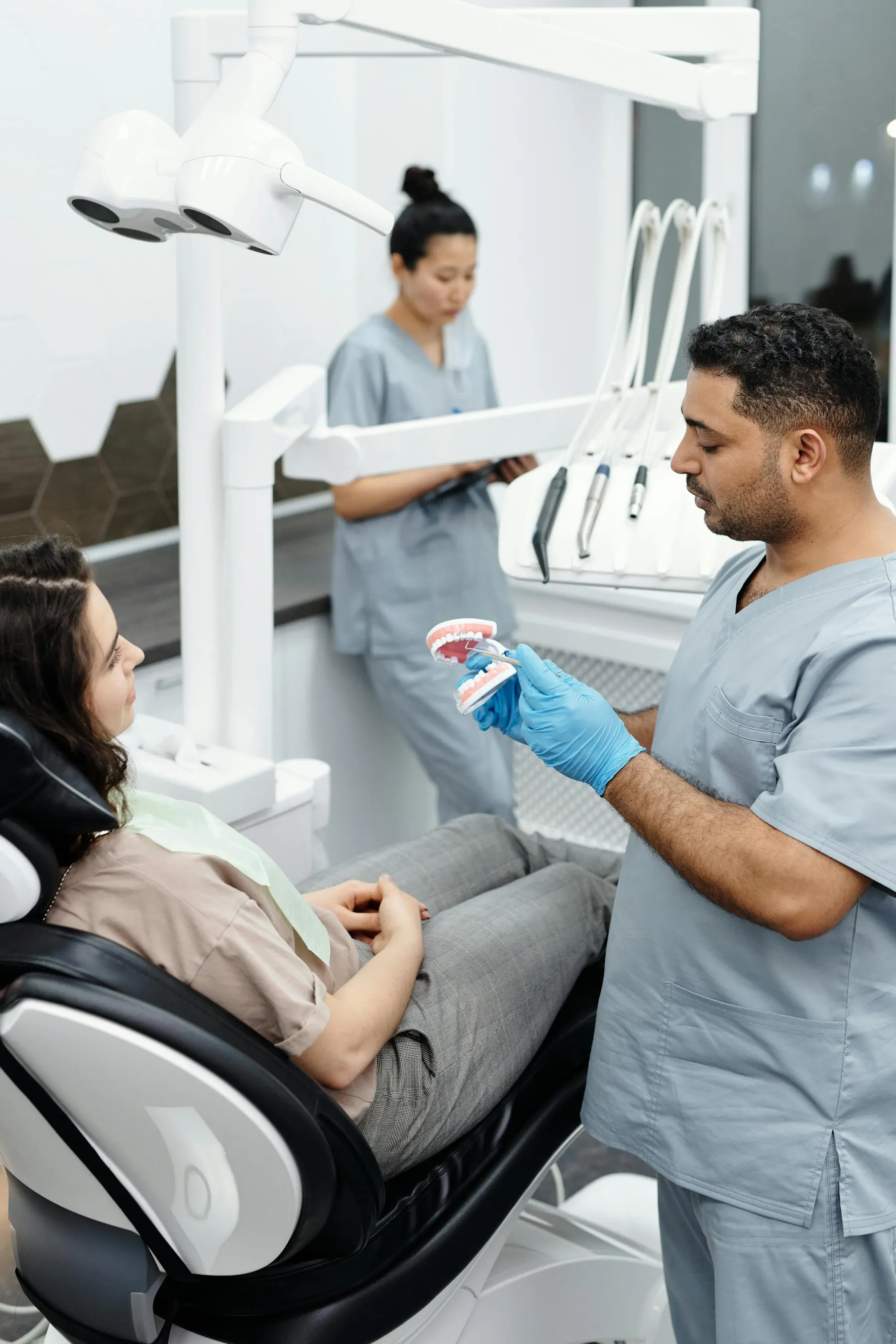 Modern white dental chair in a sunlit operatory, prepared for treatment